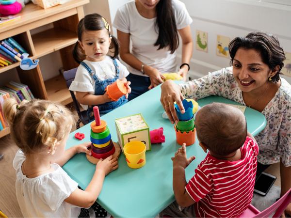 A group of young children playing at a table