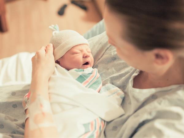 A mother holding a newborn baby in her arms