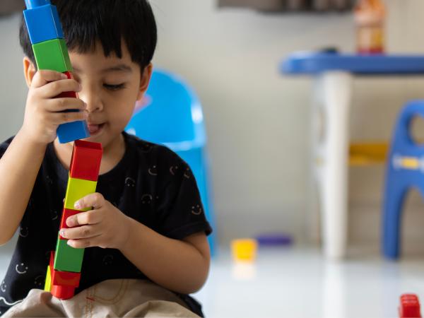 child playing with building blocks 
