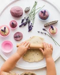 child playing with playdoh and lavender stems