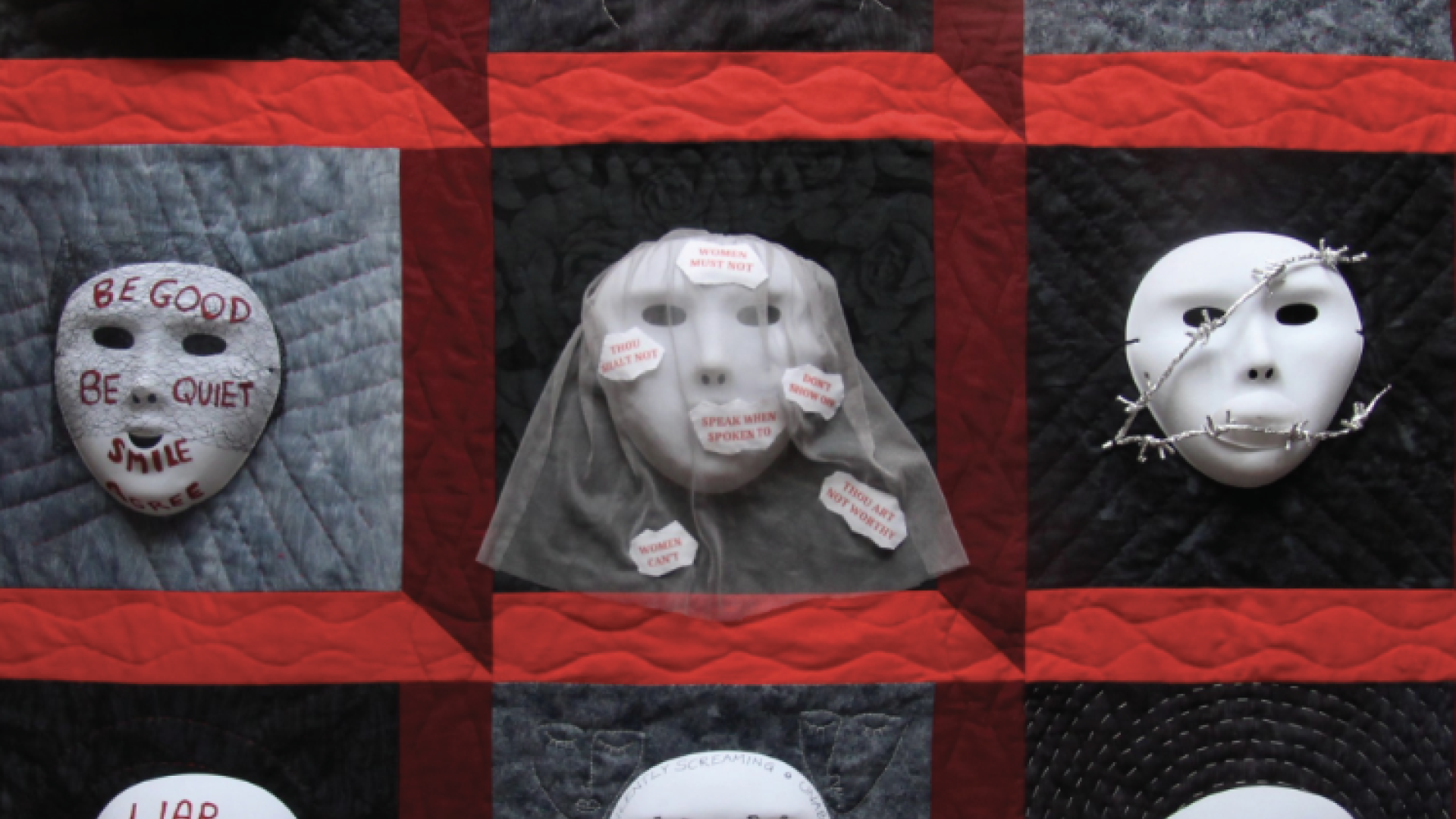Expression of Freedom Exhbition Domestic abuse art work of faces covered in words related to abuse