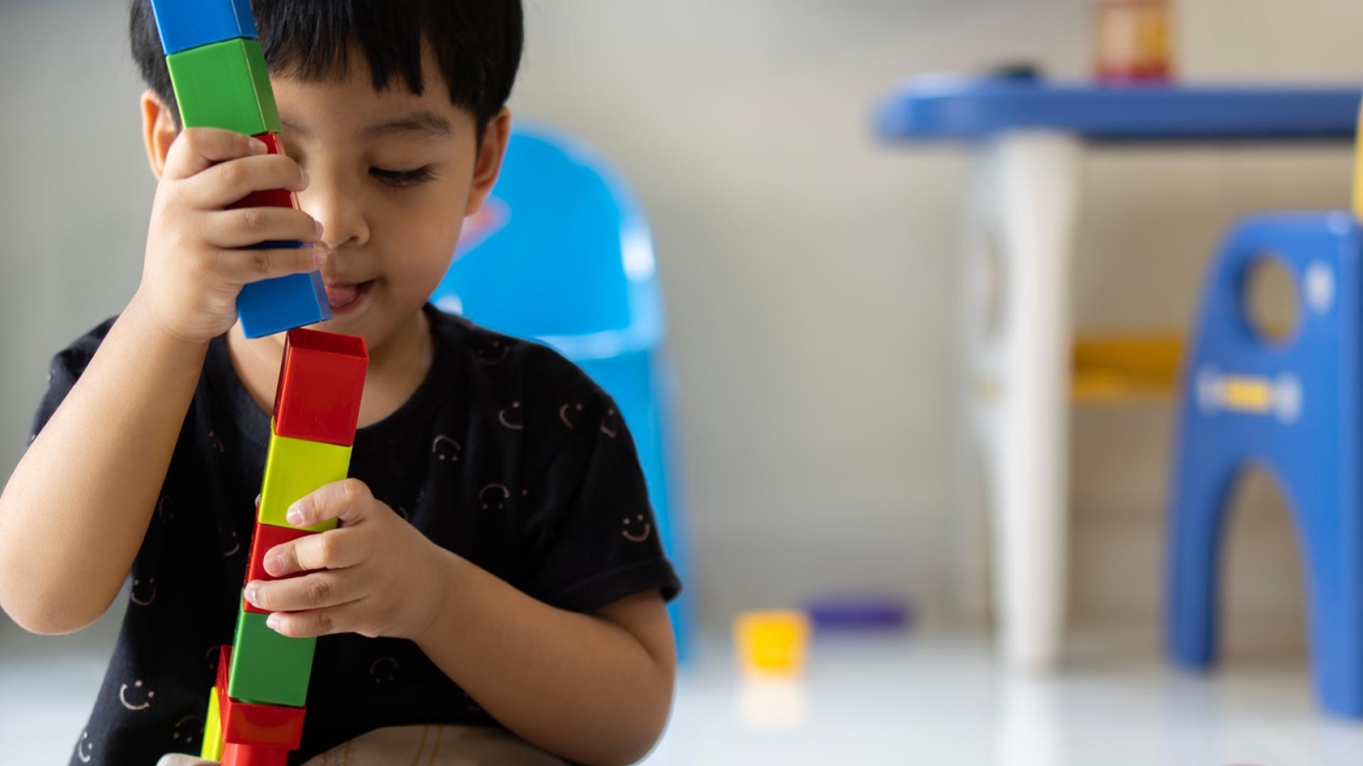 child playing with building blocks 